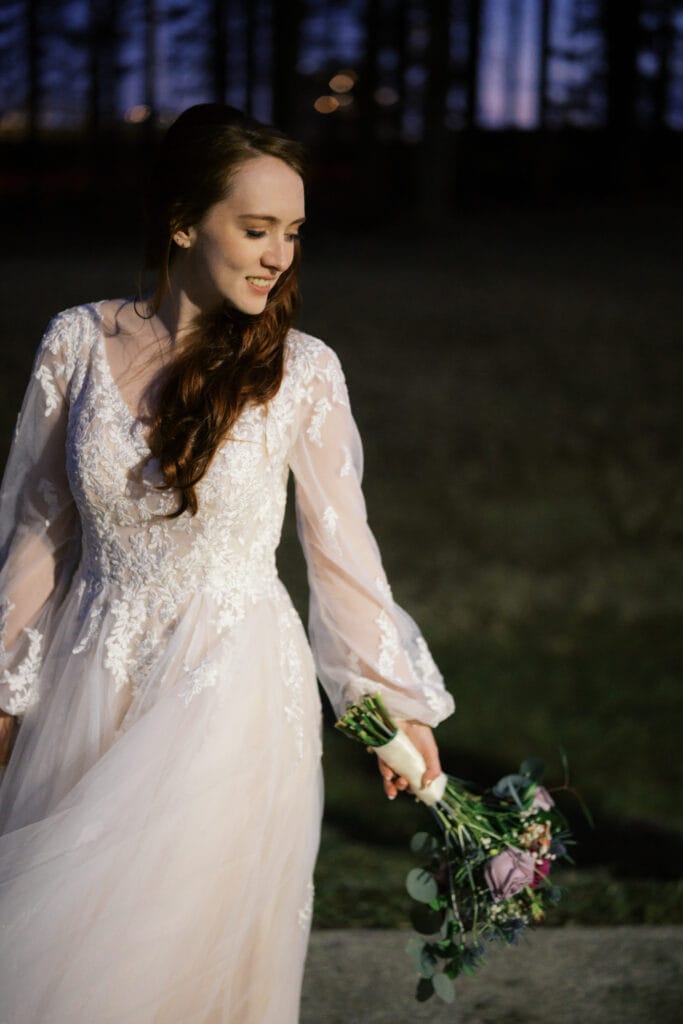 Woman in a wedding dress holding flower bouquet